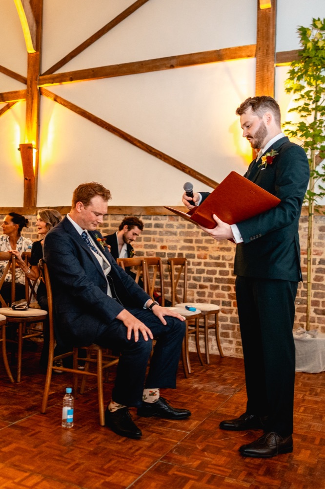 The celebrant and groom in the barn